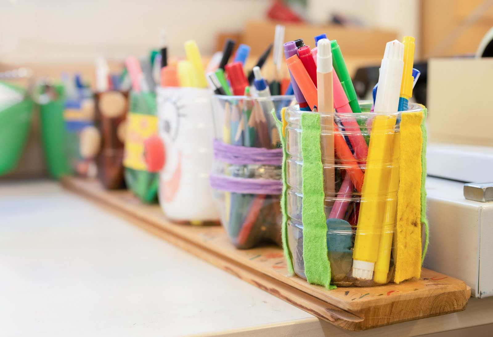 Shelf with containers of markers and pens