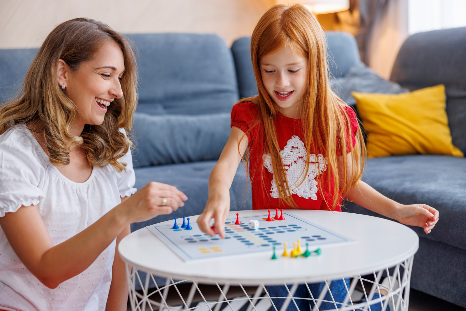 Mom plays a board game with daughter