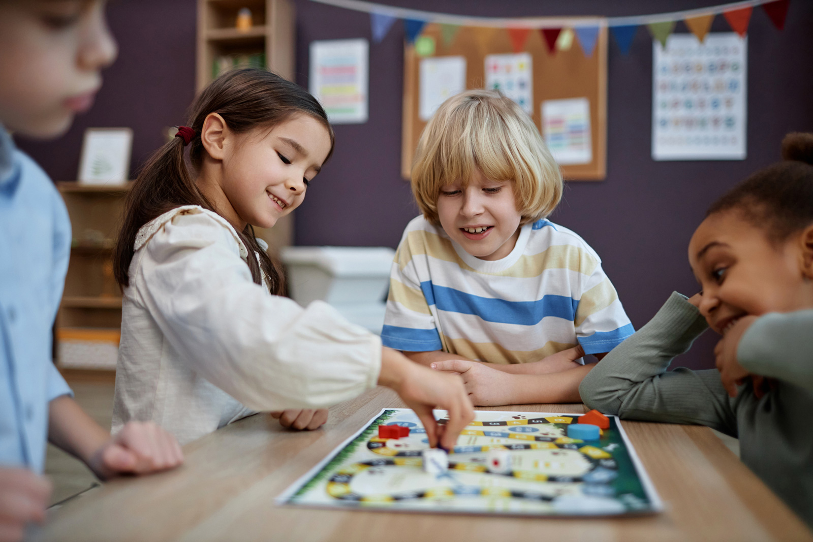 Kids play a board game