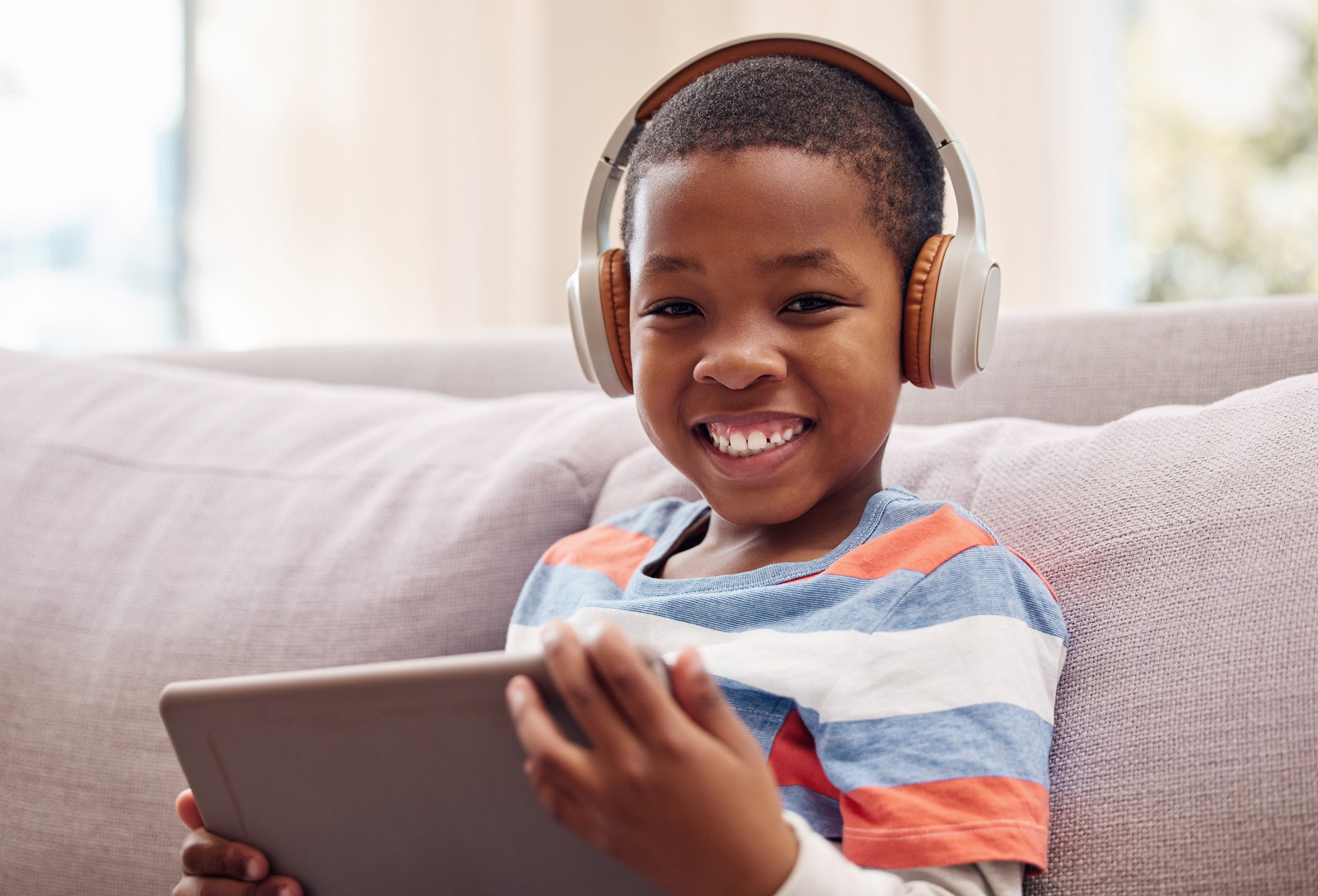 Young boy listens to a podcast